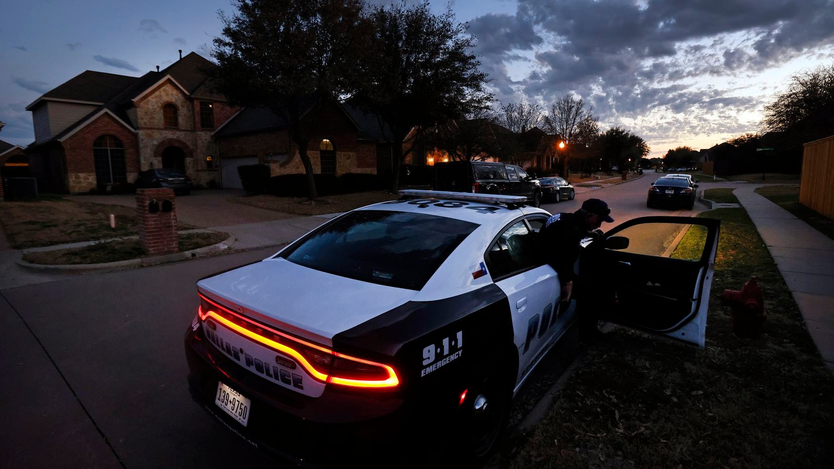 Dallas Police sit outside Eboni Samuel and Bryan Riser's home as an FBI Evidence Response...