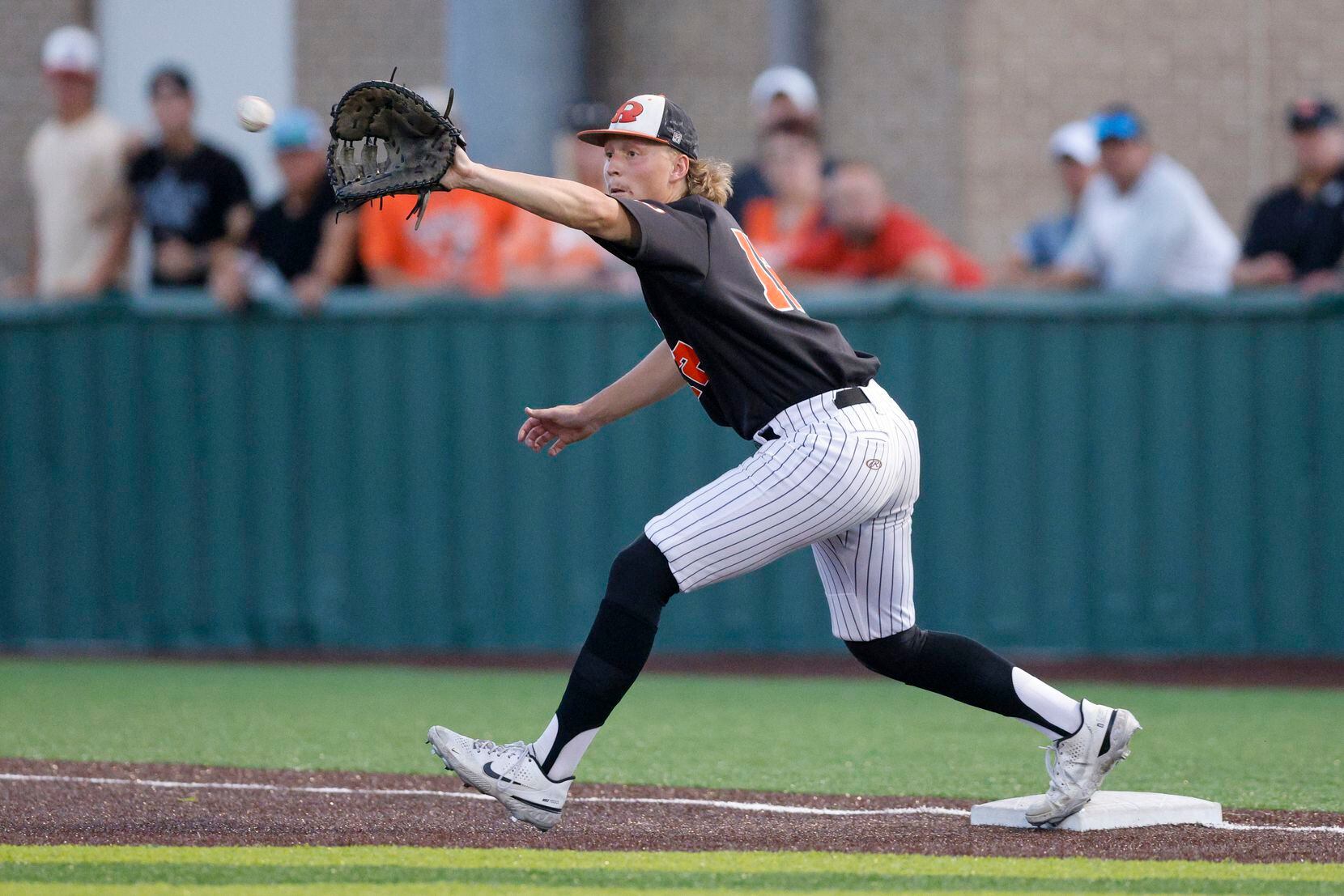 Rockwall first baseman Tag Pacot (12) stretches for the force out at first base against...