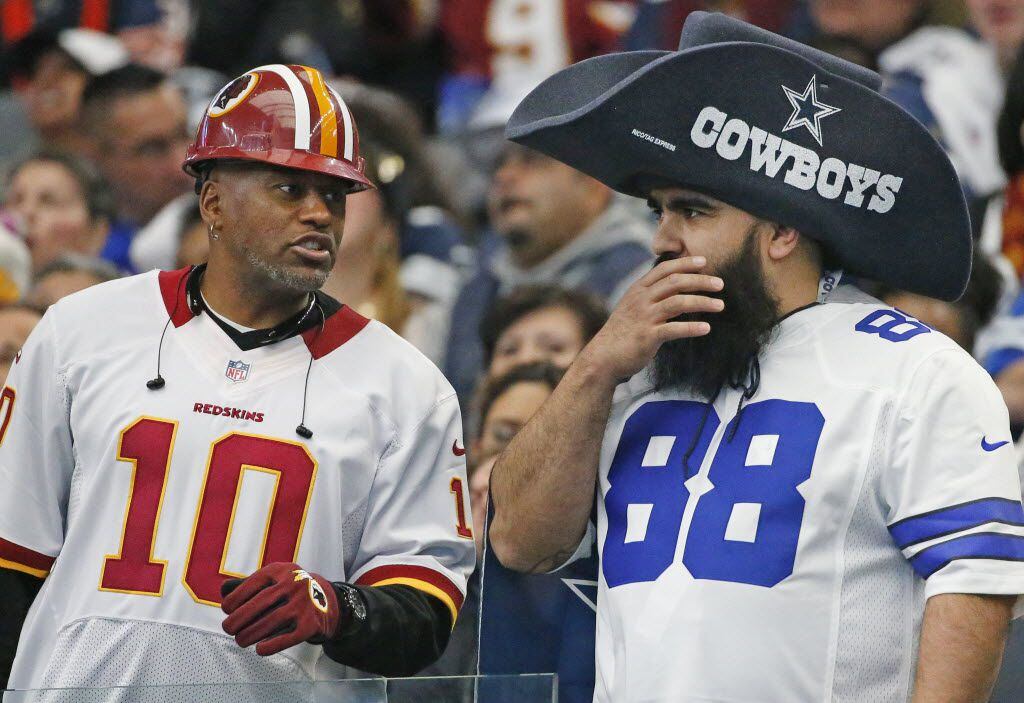 A Redskins fan talks with a Cowboys fan during Washington Redskins vs. Dallas Cowboys at...