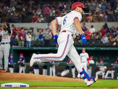 Texas Rangers catcher John Hicks rounds the bases after hitting a two-run home run off of...