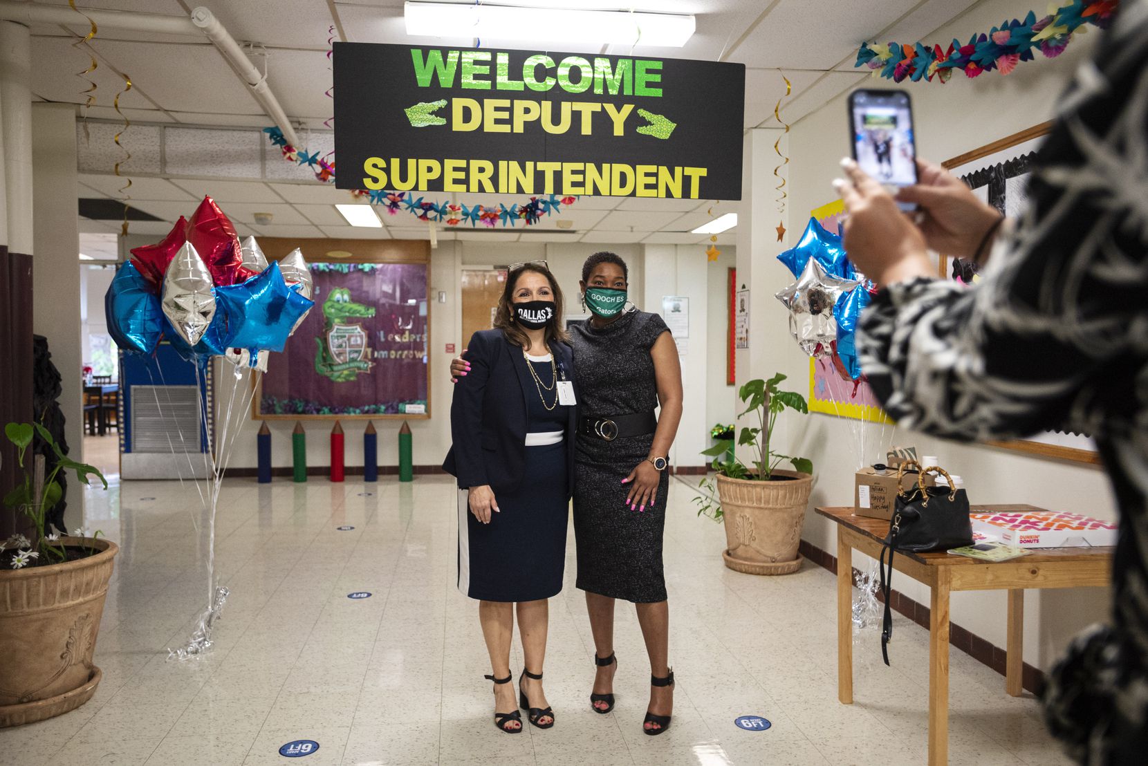 A staff member photographed Susana Cordova (left), DISD deputy superintendent, with principal Kermange Johnson before Cordova left Tom Gooch Elementary School for the next stop on her visits to three campuses that day.