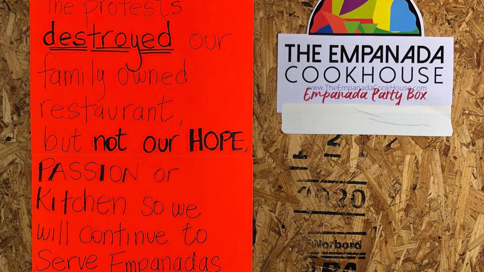 A sign on the boarded up door of Empanada Cookhouse in Downtown Dallas