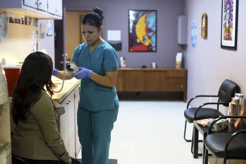 Nyla Munoz, a medical assistant, helped a patient through a pre-op appointment in McAllen in...