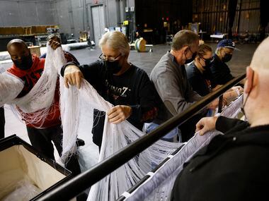 The AT&T Performing Arts Center carpenter Joey Barber (center) and crew set up a curtain...