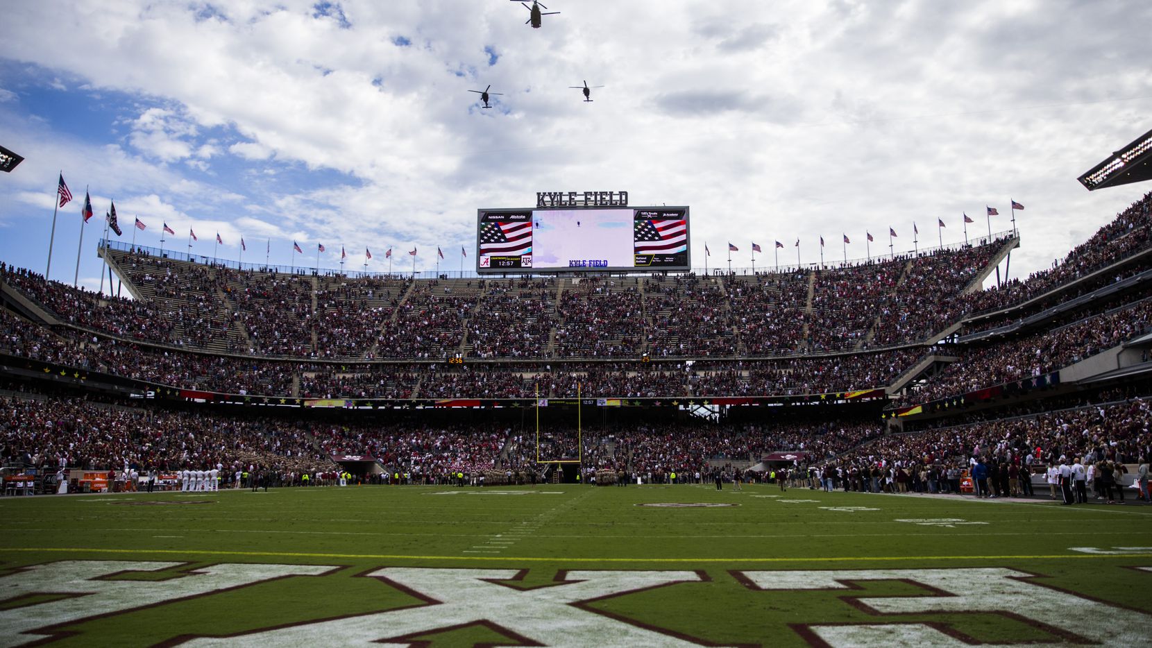 Helicopters fly over Kyle Field before a college football game between Texas A&M and Alabama...
