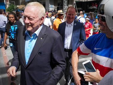 Dallas Cowboys owner Jerry Jones walks through fans before Dallas was announced as a host...