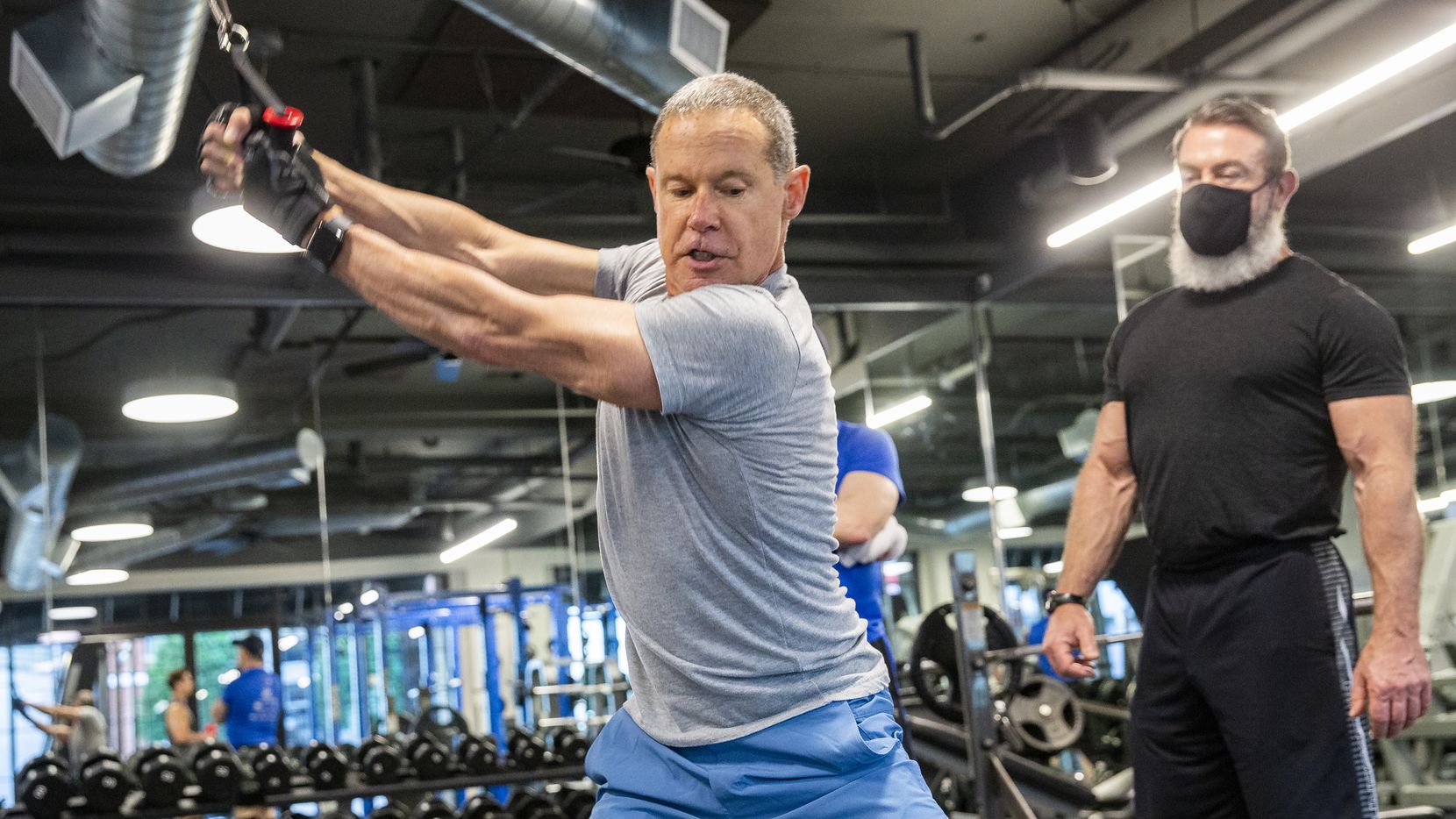 Bill Kritzer works out with Trophy Fitness trainer John Gordon at the Uptown gym on May 18, 2020 in Dallas. Kritzer said he kept active by doing a lot of cardio, running, and push-ups while the gym was closed.
