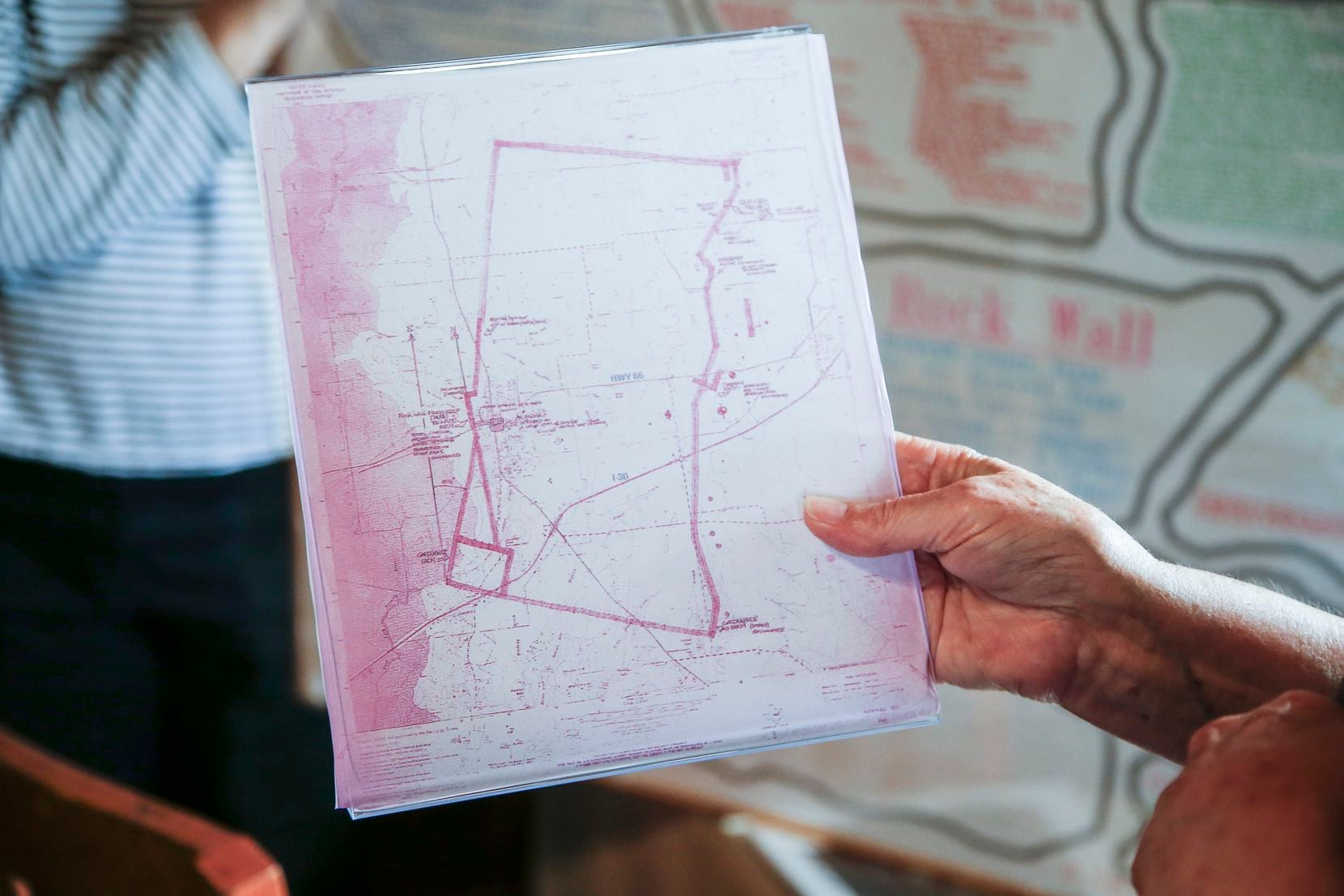 Rockwall County Historical Foundation Museum Curator Carolyn Holt holds up a map that...