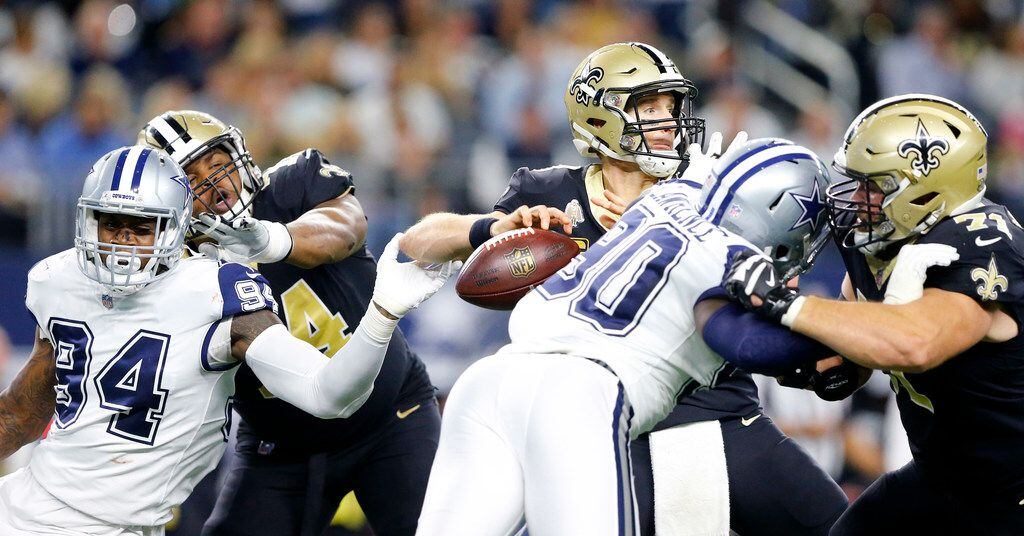 New Orleans Saints quarterback Drew Brees (9) has the ball locked from his hand by Dallas...