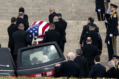  With family members following behind, pallbearers carry the casket of late Supreme Court...