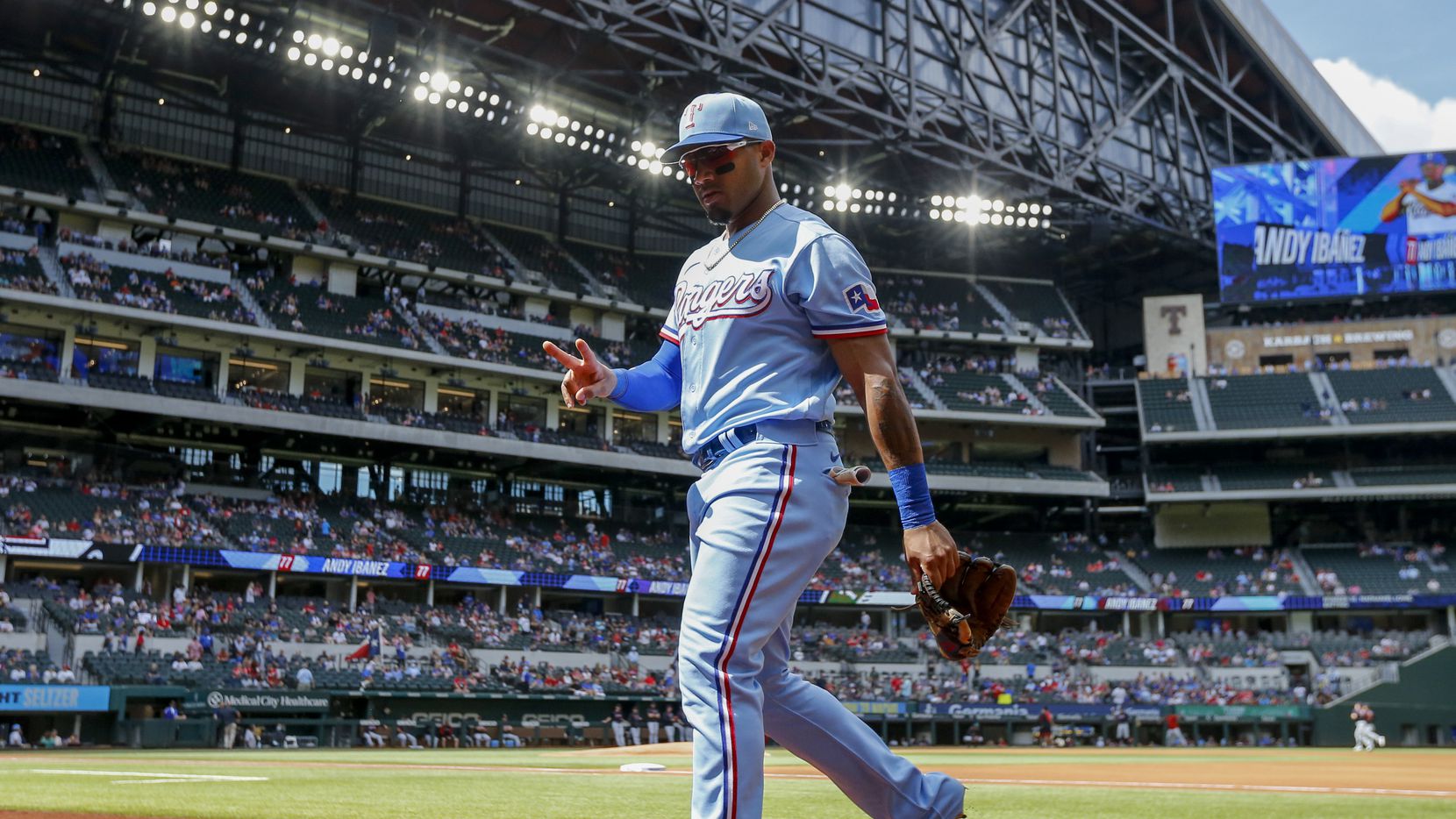 Texas Rangers second baseman Andy Ibanez (77) walks back to the dugout before the final game...