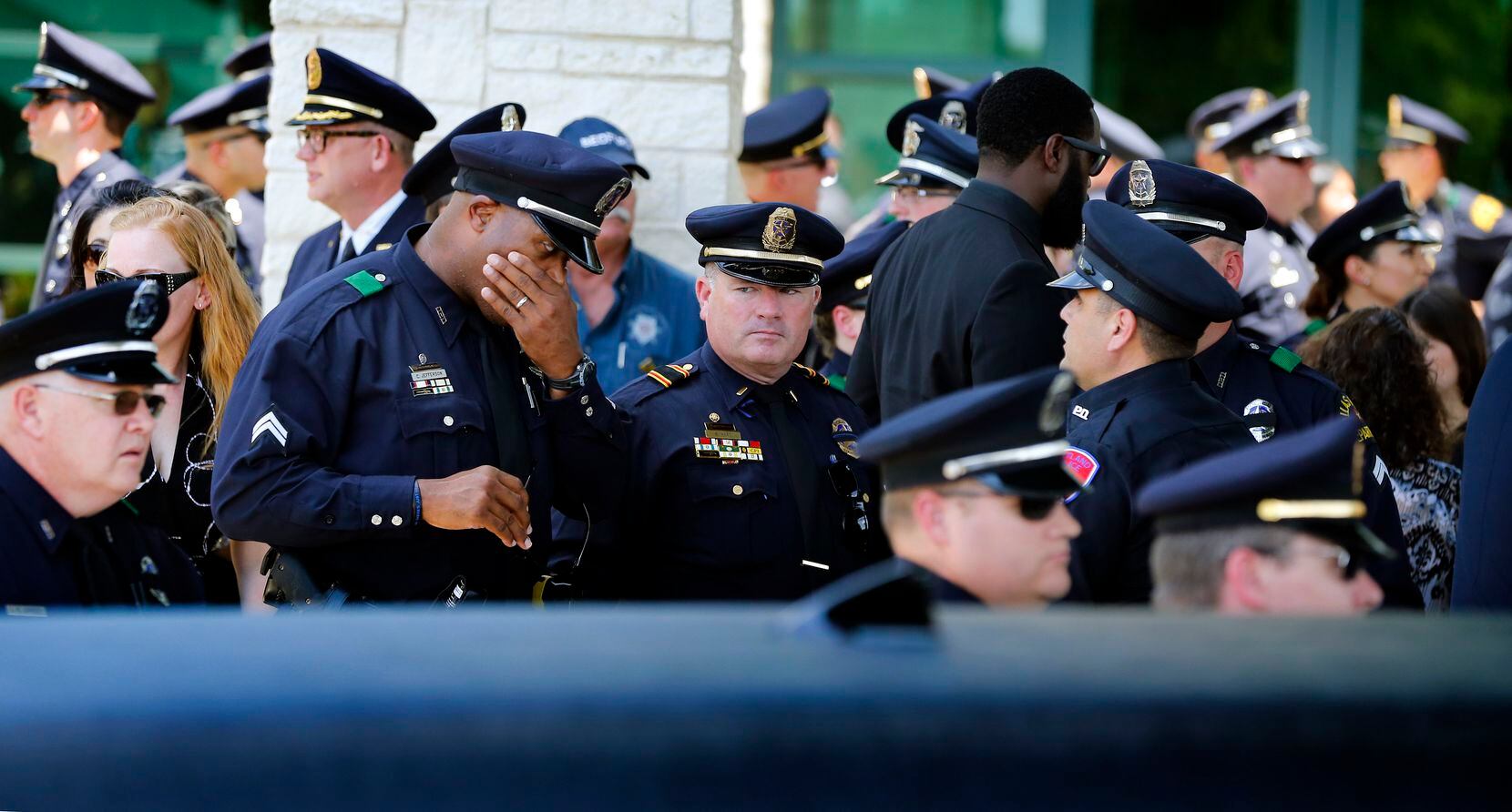 Police officers broke salute and mingled a bit before the hearse and the funeral procession...