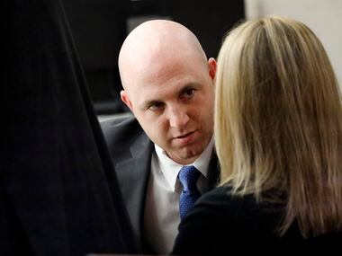 Fired Dallas police Officer Amber Guyger visits with her attorney Zach Horn (left) during a...