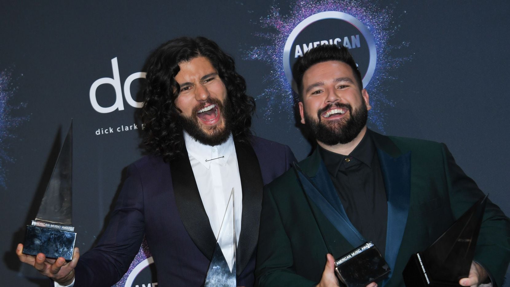Dan Smyers and Shay Mooney of the musical duo Dan + Shay pose with their awards in the press...