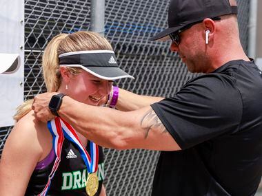Southlake Carroll’s Brennan Becicka receives her 6A girls doubles championship medal from...