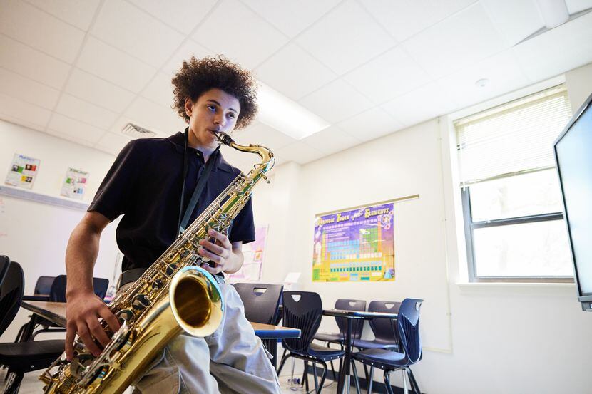 West Dallas student Gabriel Carvajo plays the saxophone in a school classroom.