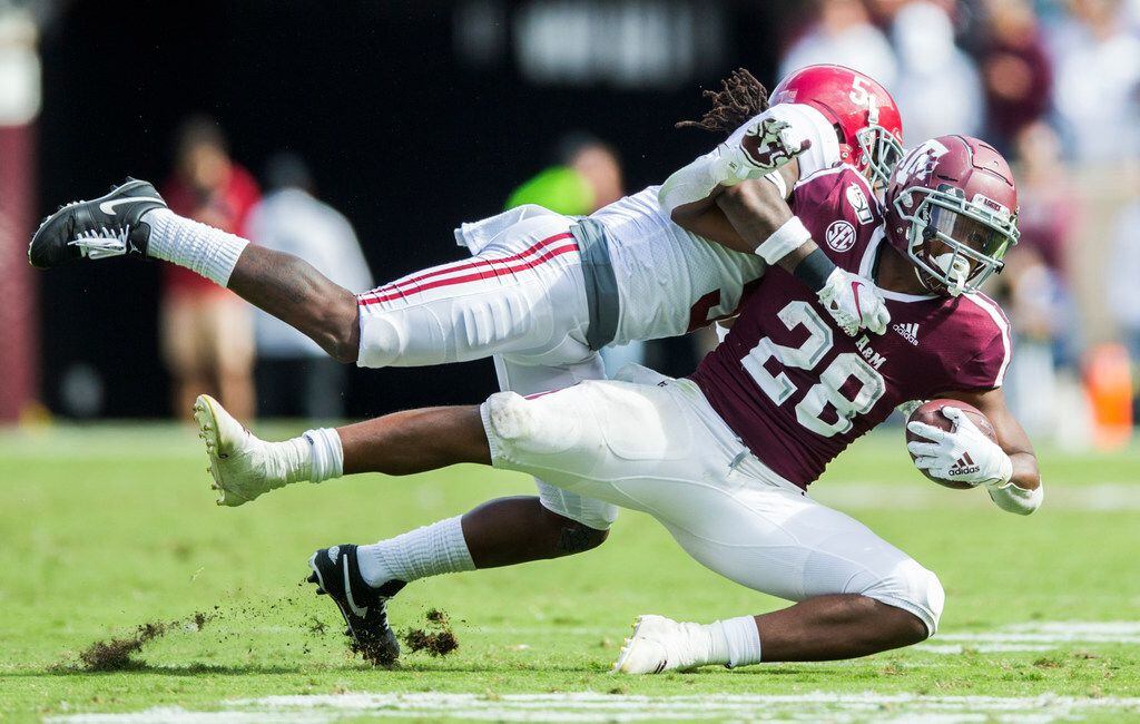 Texas A&M Aggies running back Isaiah Spiller (28) is tackled by Alabama Crimson Tide...