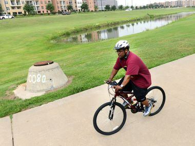 Andre Herron rides his bike along the trails in Irving's Las Colinas. A new study found that Irving residents and a handful of other North Texas cities might have a tougher time getting — and staying — fit.