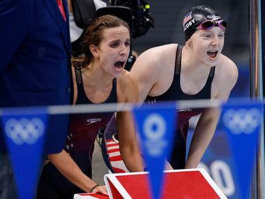 USA’s Regan Smith and Lydia Jacoby cheer on Abbey Weitzeil as she competes in the women’s...