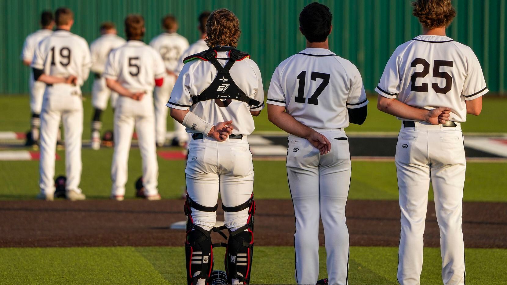 Rockwall-Heath players, including catcher Kevin Bazzell (9), pitcher Josh Hoover (17) and...