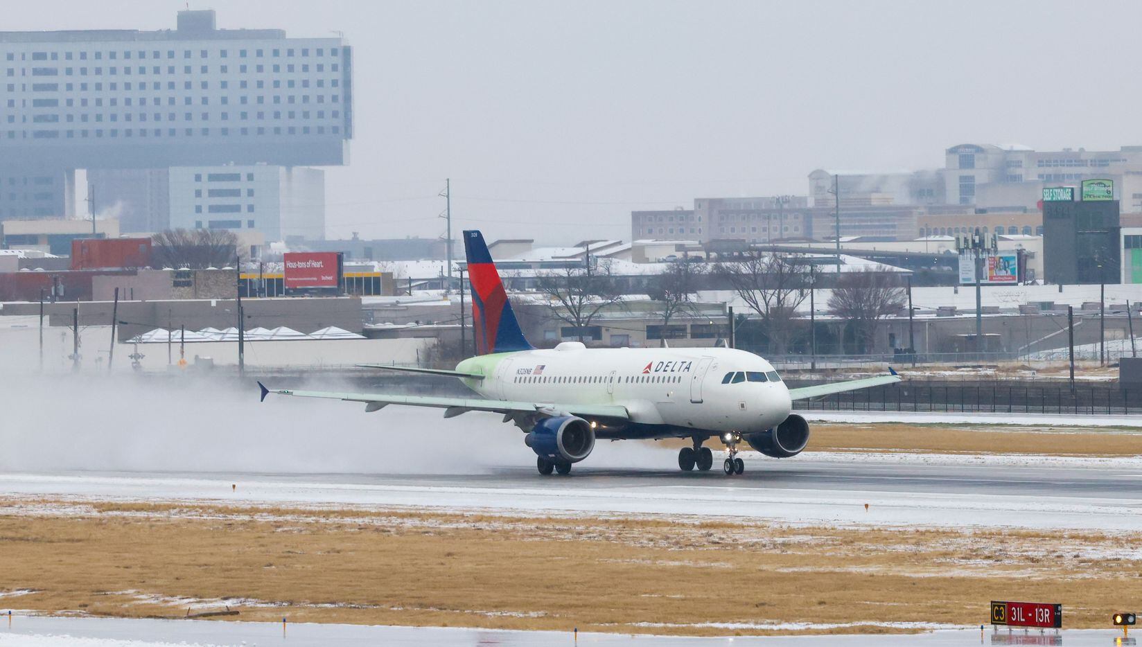 A plane with Delta Air Lines takes off at Dallas Love Field Airport in Dallas on Wednesday,...