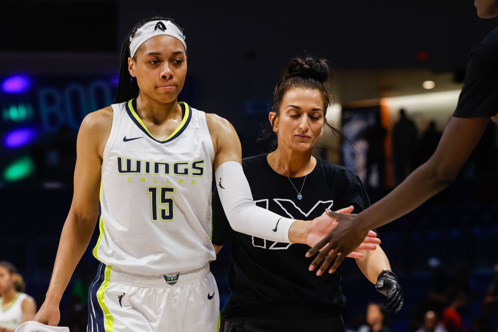 Dallas Wings guard Allisha Gray (15) leaves the court after spraining her ankle during the...