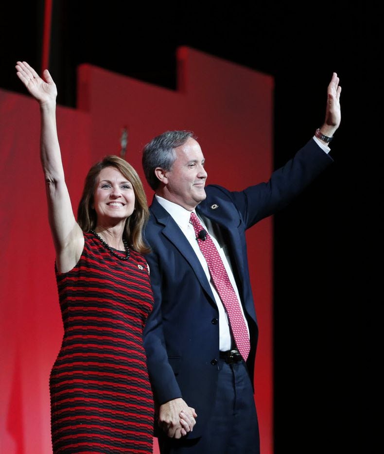 Texas Attorney General Ken Paxton and wife Angela wave to the crowd during the 2016 Texas...