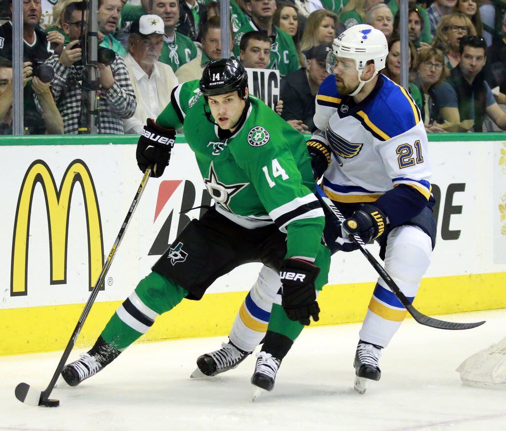 Dallas Stars left wing Jamie Benn (14) circles the back of the net with St. Louis Blues...