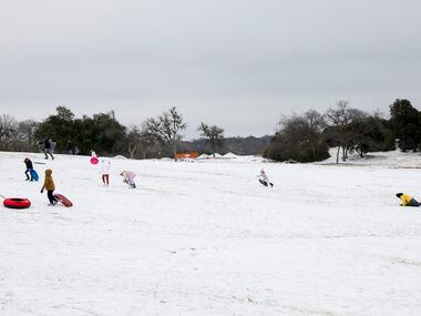 Families and friends sled at Flag Pole Hill in Dallas, Tuesday, Jan. 31, 2023. Freezing rain...