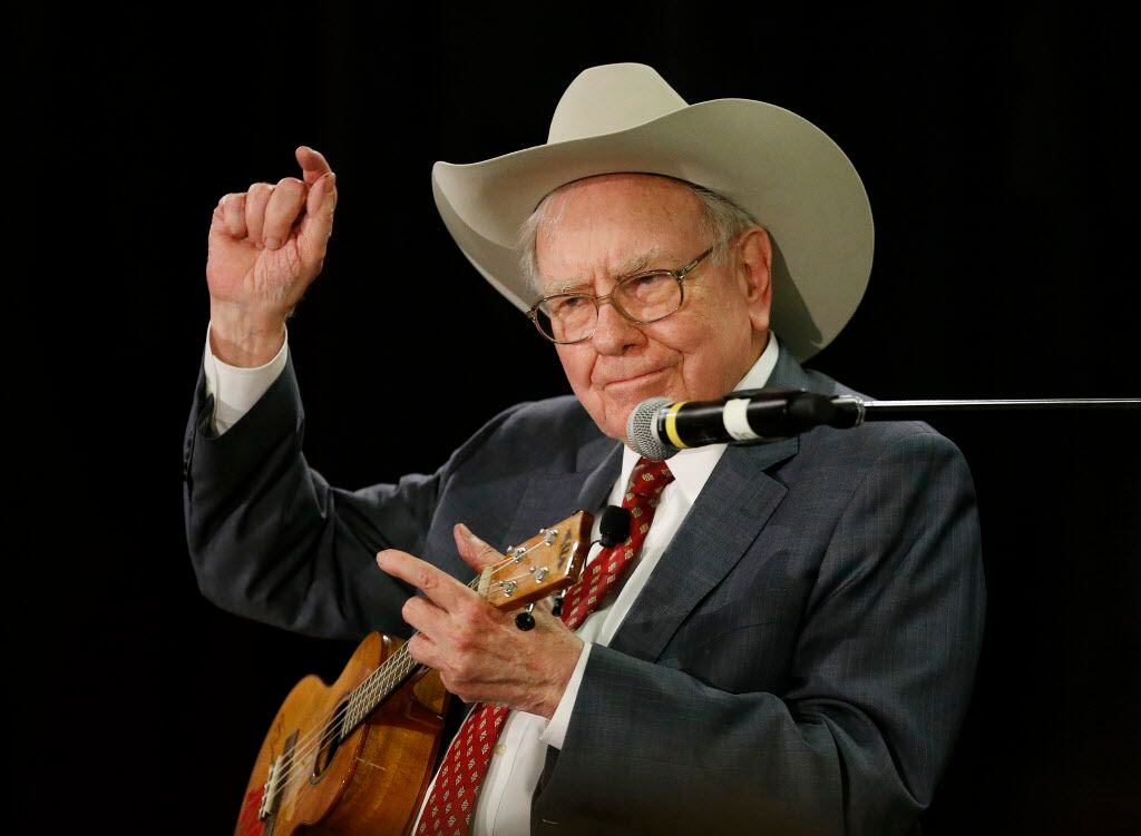 Warren Buffett, the CEO of Berkshire Hathaway, plays the ukelele at a charity event at...