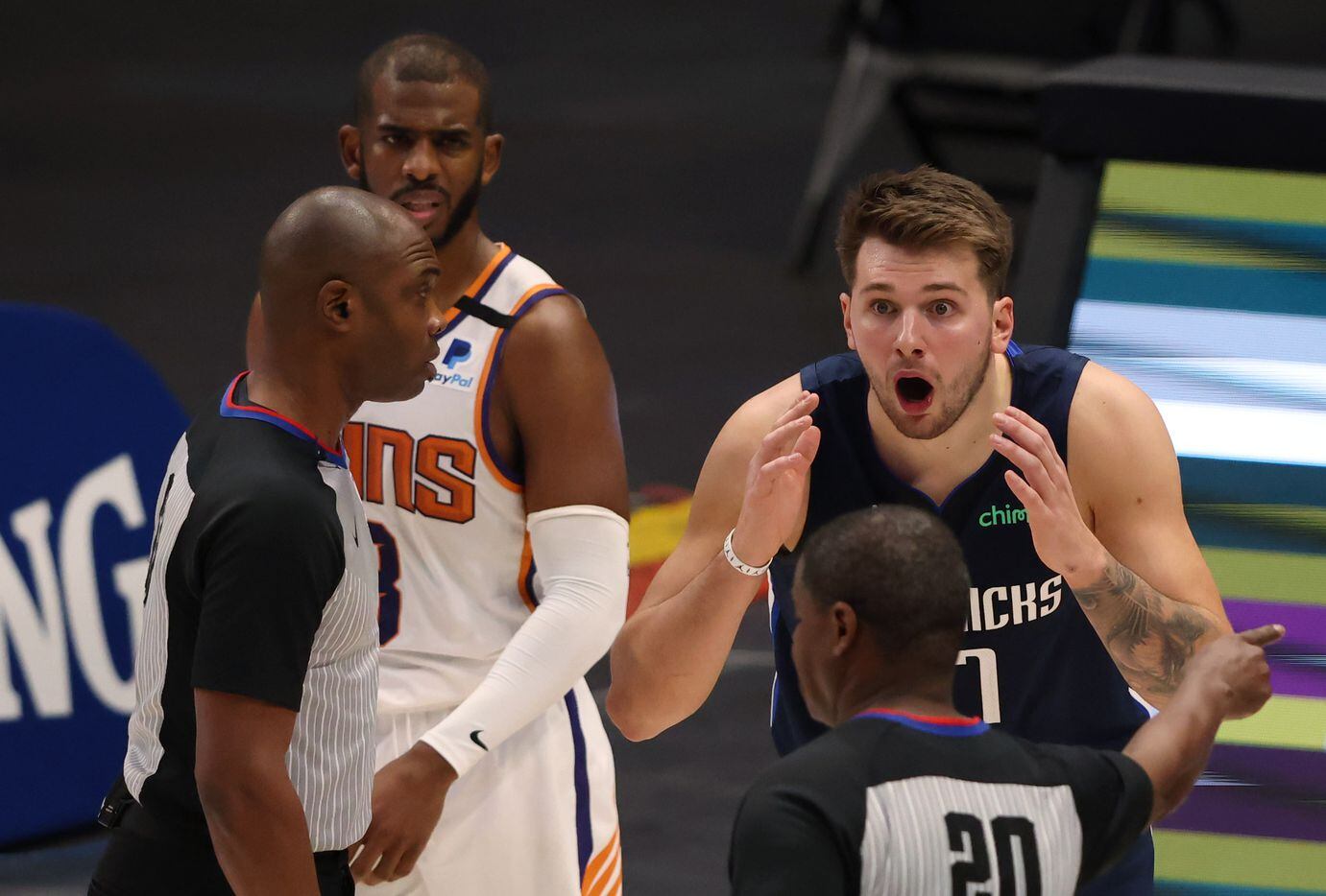 Dallas Mavericks guard Luka Doncic (77) questions the call from referee Leroy Richardson (20) as Phoenix Suns guard Chris Paul (3) looks on during the fourth quarter of play at American Airlines Center on Monday, February 1, 2021in Dallas. The Dallas Mavericks lost to the Phoenix Suns 109-108. (Vernon Bryant/The Dallas Morning News)