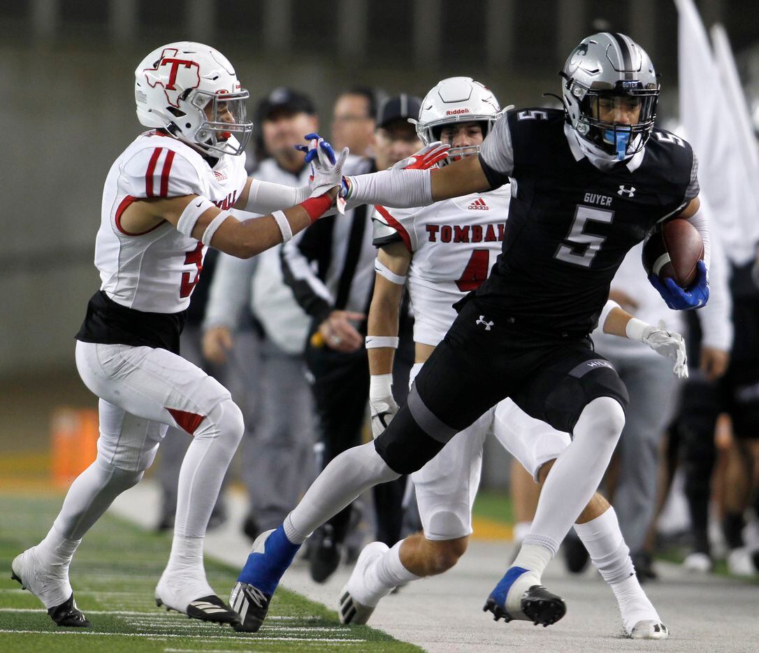Denton Guyer receiver Jace Wilson (5) tacks on first down yardage following a first quarter reception before being knocked out of bounds by Tomball defensive back Brandon Perry (5). The two teams played their  Class 6a Division ll state semifinal football playoff game at Baylor's McLane Stadium in Waco on December 11, 2021. (Steve Hamm/ Special Contributor)