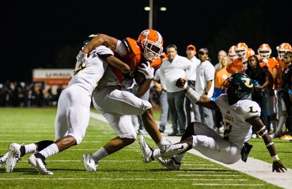 Rockwall wide receiver Jaxon Smith-Njigba (11) is tackled by Longview defensive backs...