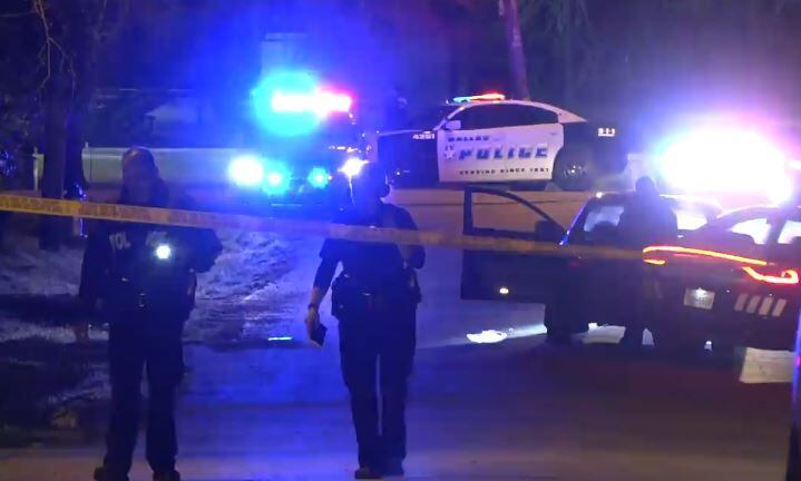Dallas police search an area near where a man was shot Thursday night in west Oak Cliff.