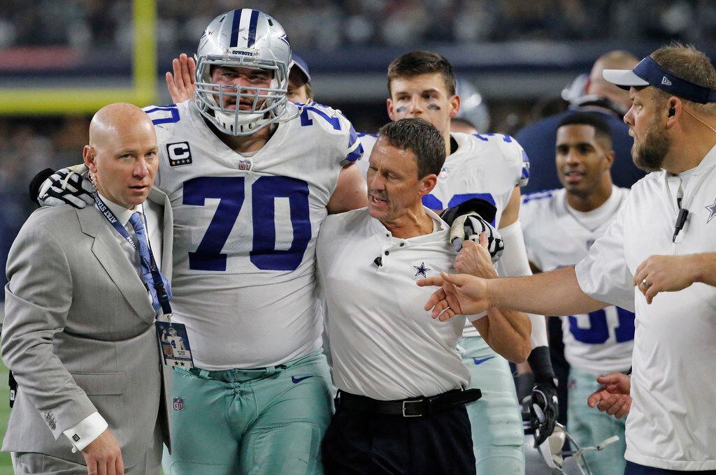Dallas Cowboys offensive guard Zack Martin (70) is helped off the field after being injured ...