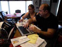 Jesus and Claudia Fierro of Yuma, Ariz., review their high medical bills. They report paying...