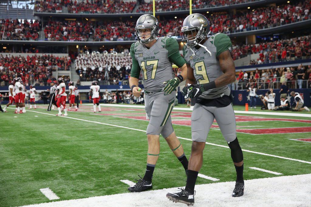 Baylor Bears quarterback Seth Russell (17) and wide receiver KD Cannon (9) walk off the...