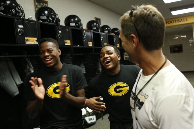 Jeff Jordan, head football coach at Garland High School, laughs with Devonte Hayden, left,...