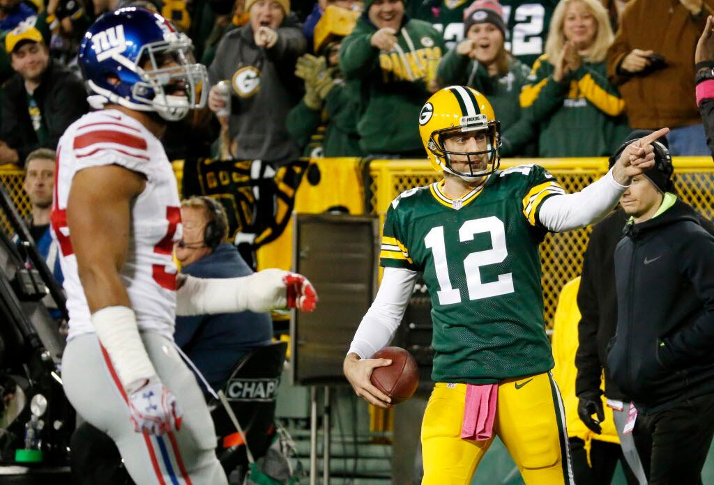 Green Bay Packers' Aaron Rodgers reacts to his first down run during the first half of an...