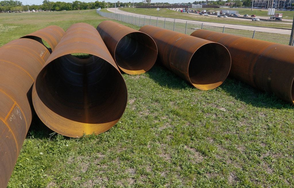 Large pipes lay on undeveloped land at Skillman Street and LBJ Freeway in Dallas on April...