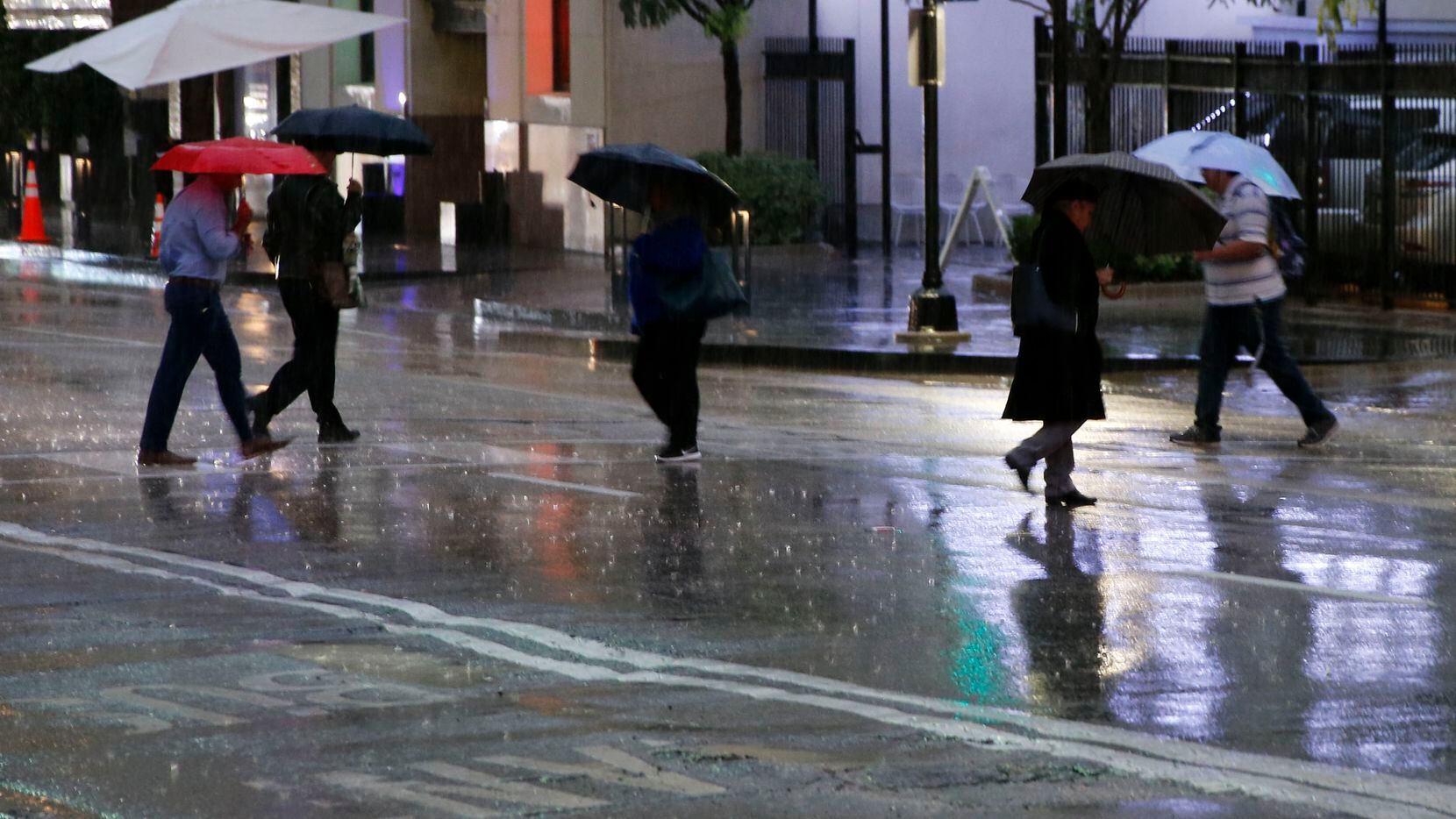 People make their way through wet and cold conditions as temperatures dropped into the 40's...