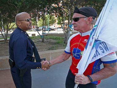 Assistant Chief John Lawton (left) shakes hands with William Harold Hixon, a retired San...