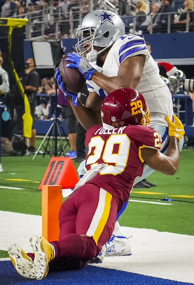 Dallas Cowboys wide receiver Amari Cooper (19) catches a 13-yard touchdown pass as Washington Football Team cornerback Kendall Fuller (29) defends during the first half of an NFL football game at AT&T Stadium on Sunday, Dec. 26, 2021, in Arlington.