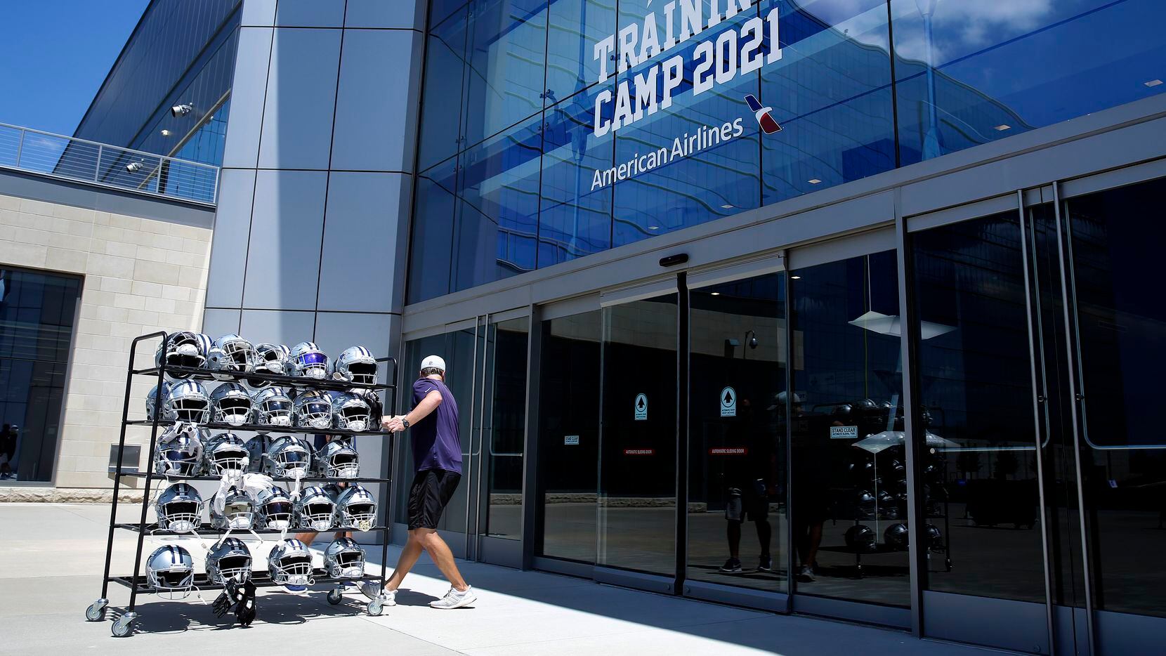 A rack full of players helmets are carted inside following Training Camp practice at The Star in Frisco, Texas, Wednesday, August 25, 2021.