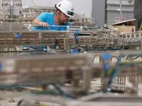 Brett Howard works on a conveyer belt that'll soon carry SunOpta products through a sterile...