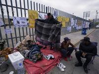 Protest signs cover the fence outside the Mexican immigration detention center that was the...