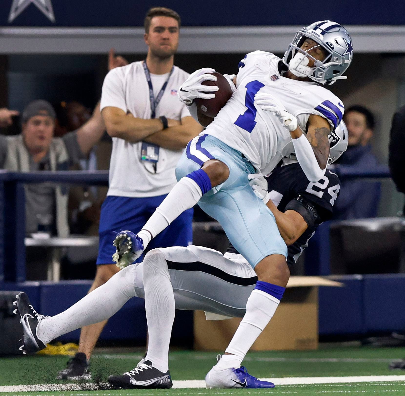 Dallas Cowboys wide receiver Ced Wilson (1) is spin around and out of bounds by Las Vegas Raiders safety Johnathan Abram (24) after a long second quarter pass completion at AT&T Stadium in Arlington, November 25, 2021. (Tom Fox/The Dallas Morning News)