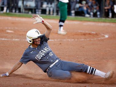 The Colony's Jayda Coleman (10) slides safely into third base against Birdville during game...