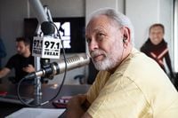 Radio legend Mike Rhyner listens to the intro of the sports talk radio show The Downbeat, on...