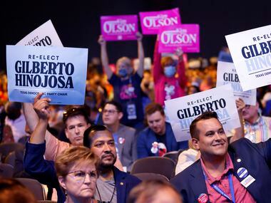 Supporters of incumbent Gilberto Hinojosa and challenger Kim Olson cheer their support...